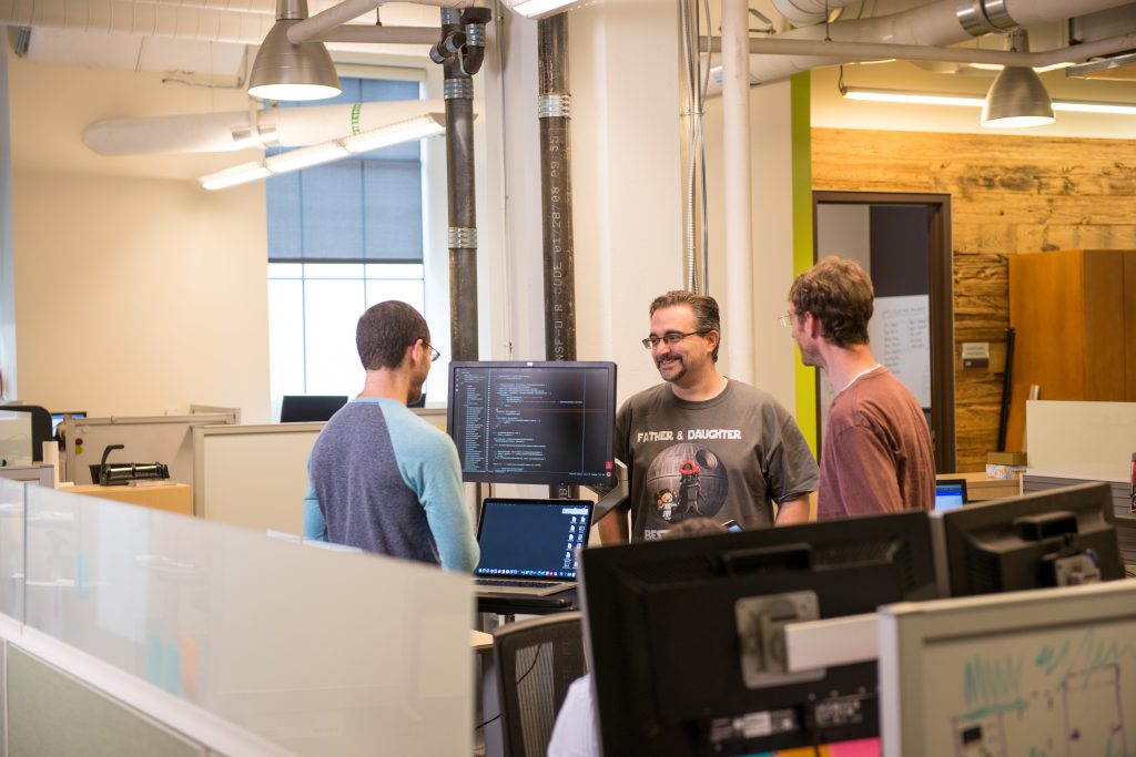 UPMC Enterprises employees talking in the office